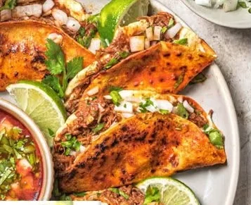 Quesabirria on a plate from an original Taco Libre menu design
